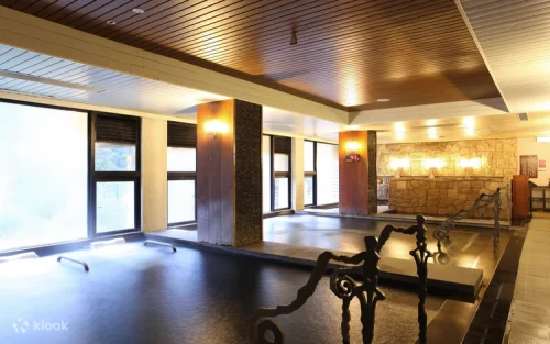 Serene emerald river flowing past the luxurious wellness retreat